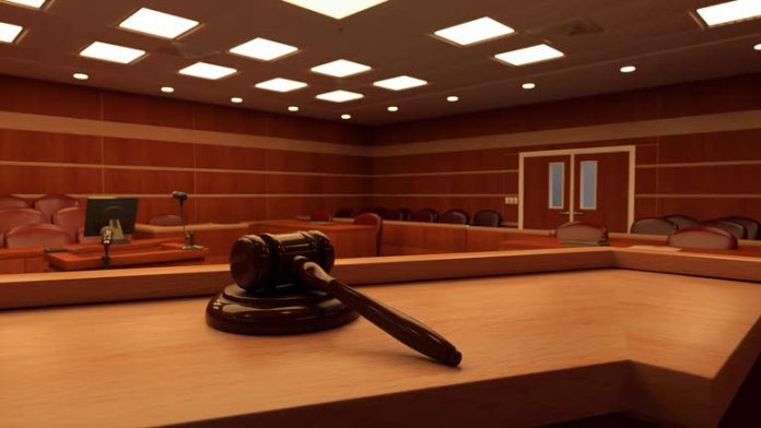 Slow motion pan towards a gavel in a courtroom